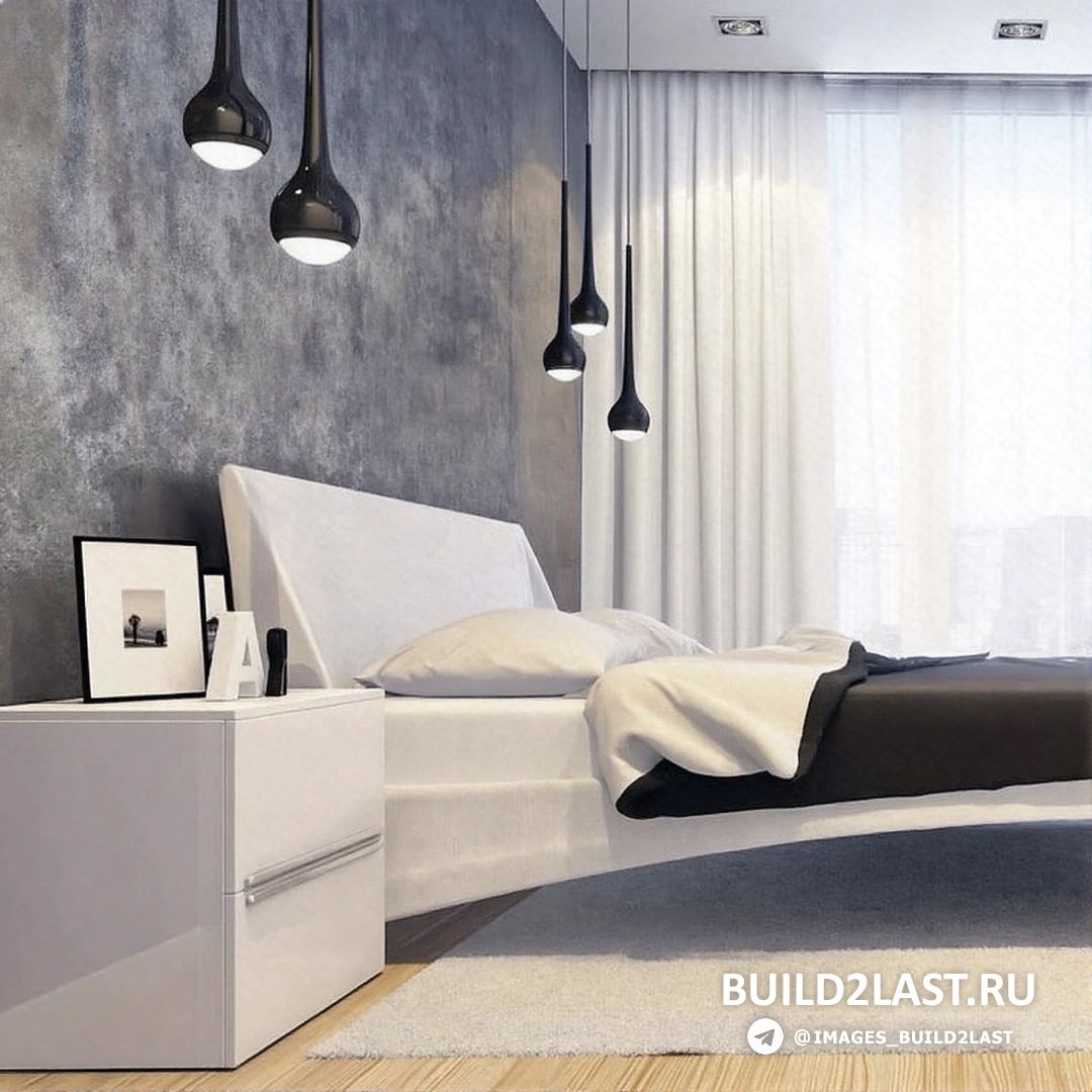 Спальня с большим окном, через которое светит естественный свет, минималистичная мебель и растения в углу.